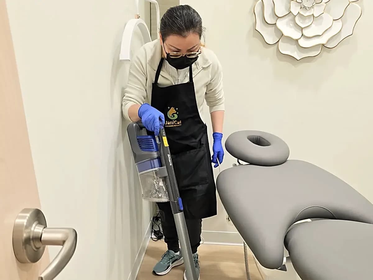 Janicat cleaner vacuuming a treatment room